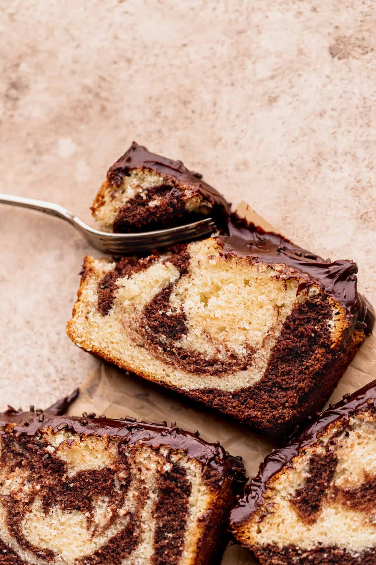 Fork inserted into chocolate marble loaf cake.