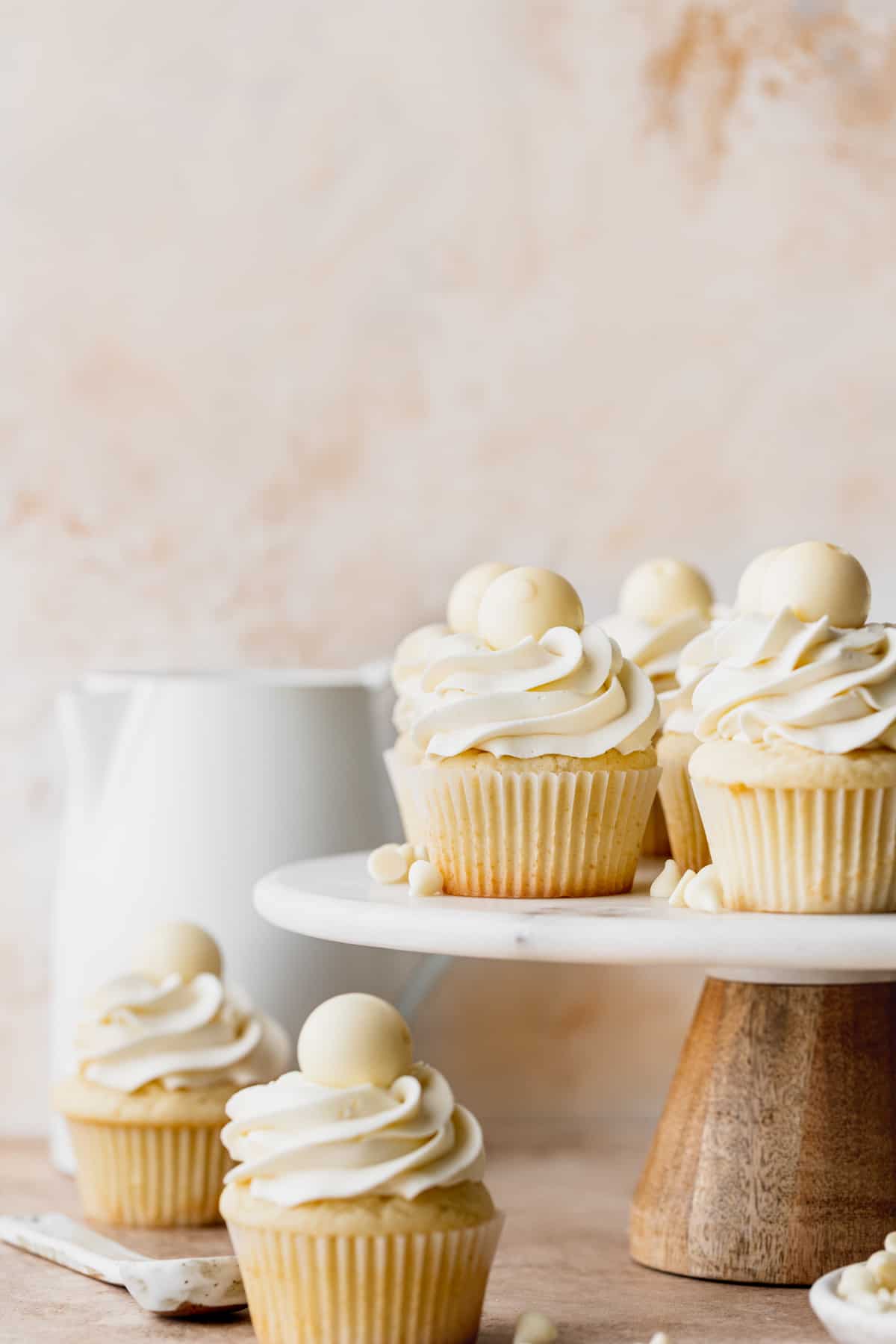 White chocolate truffle cupcakes on a cake stand.