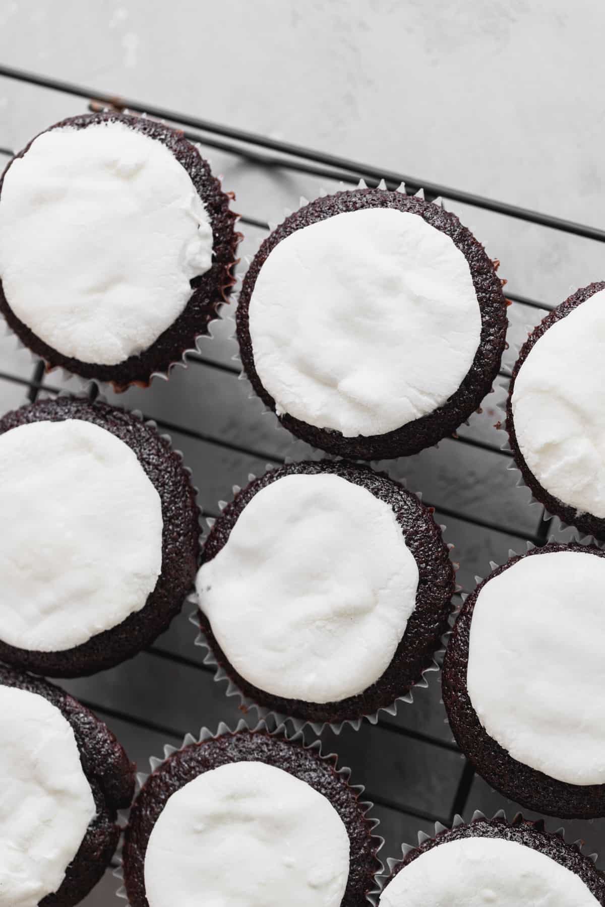 Marshmallows on top of cupcakes.