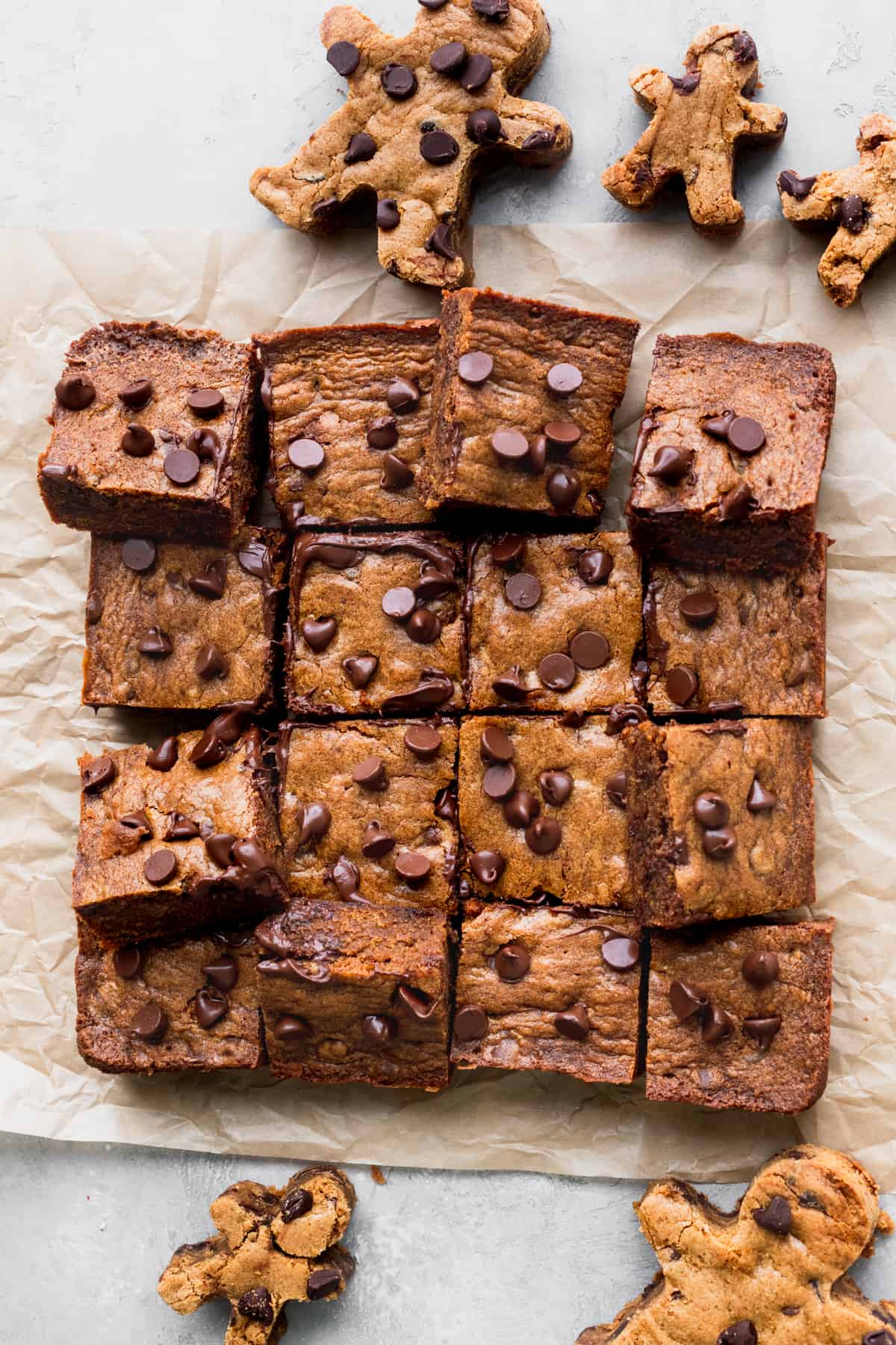 Gingerbread chocolate chip blondies cut on a parchment paper.