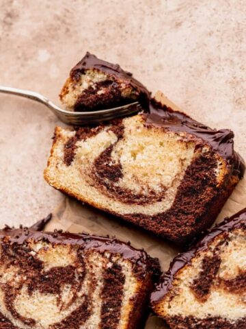 Fork inserted into chocolate marble loaf cake.