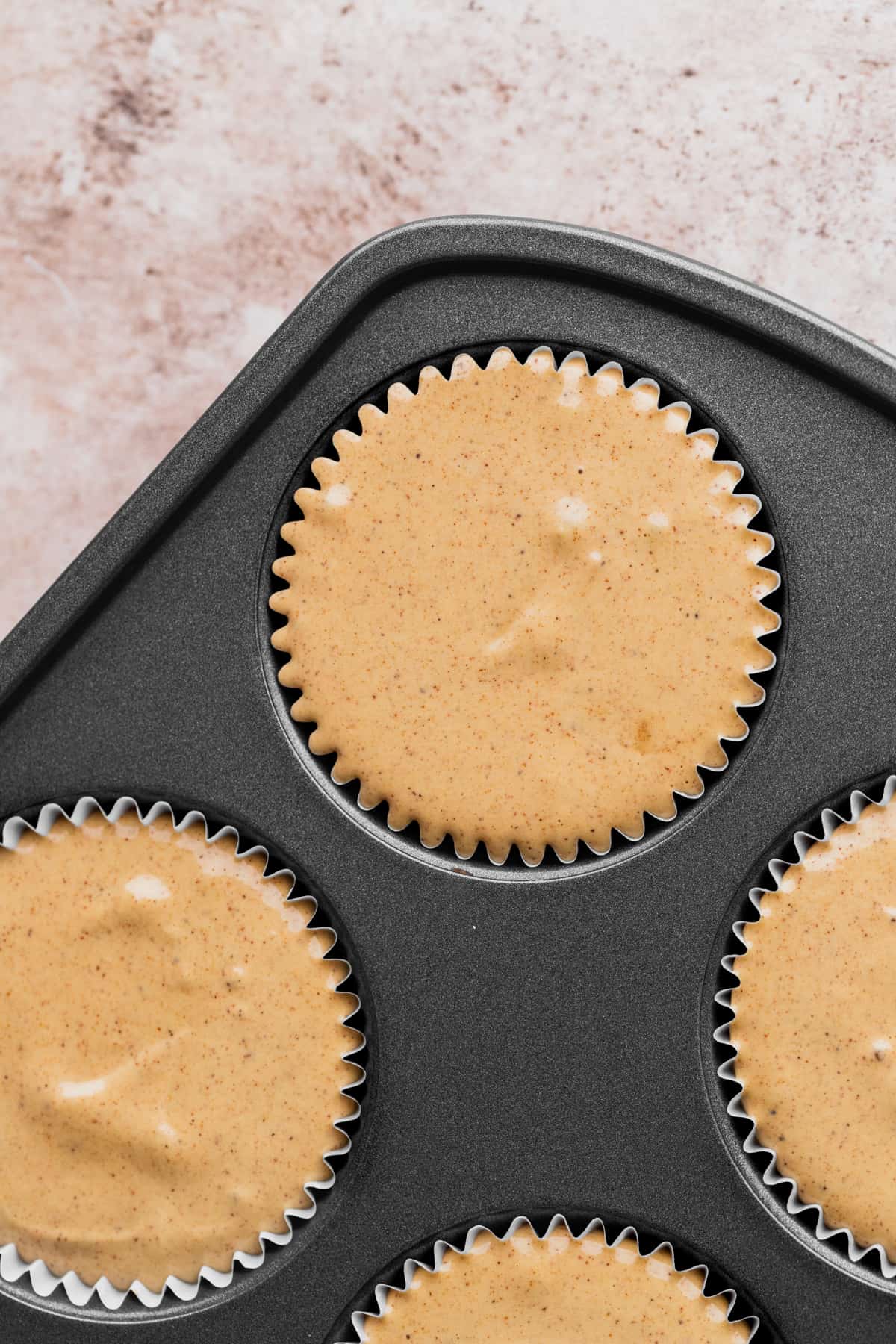 Cheesecake batter in a muffin pan.