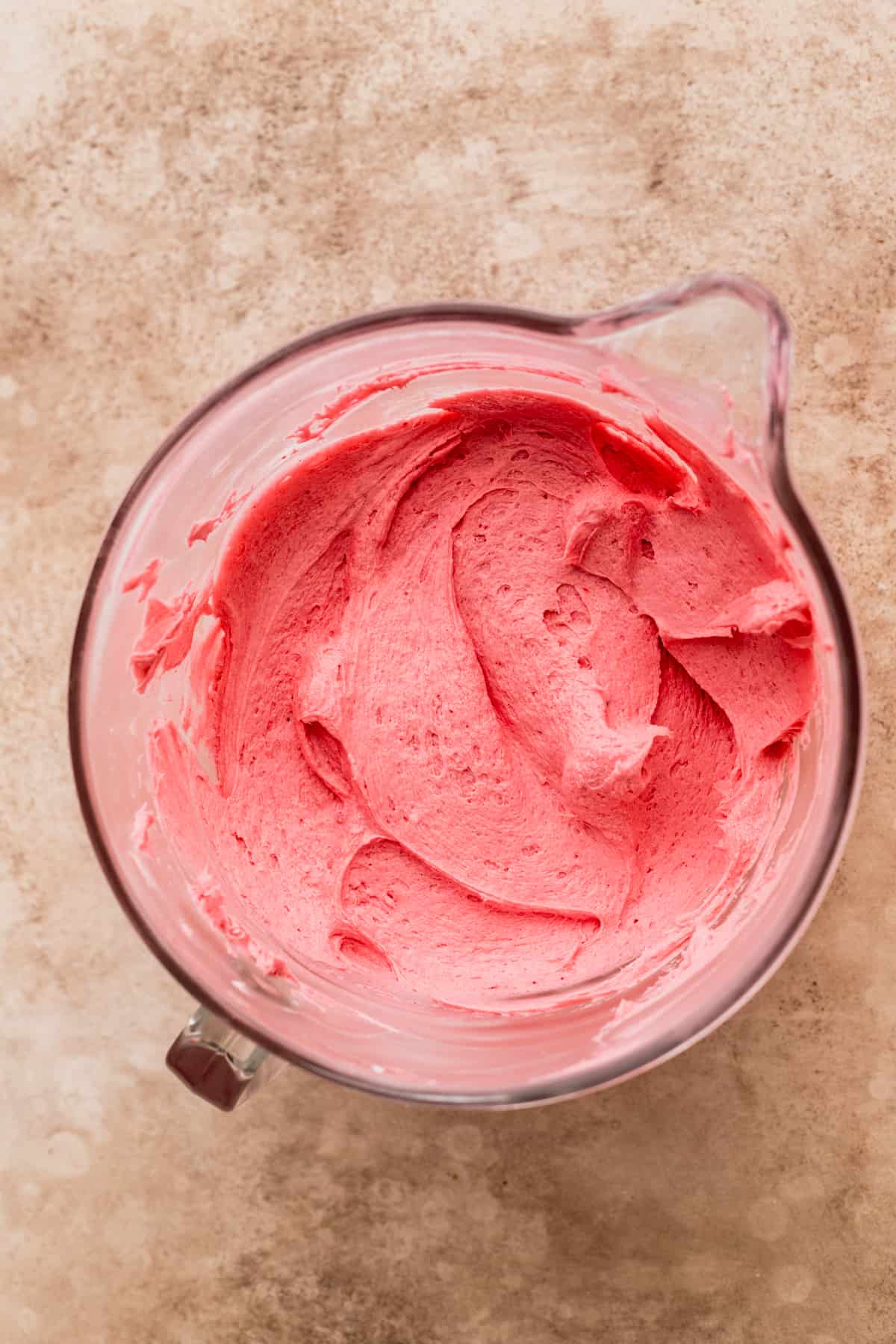 Cranberry frosting in a bowl.