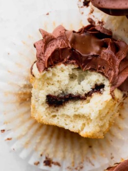Bite missing from easy vanilla Nutella cupcakes.