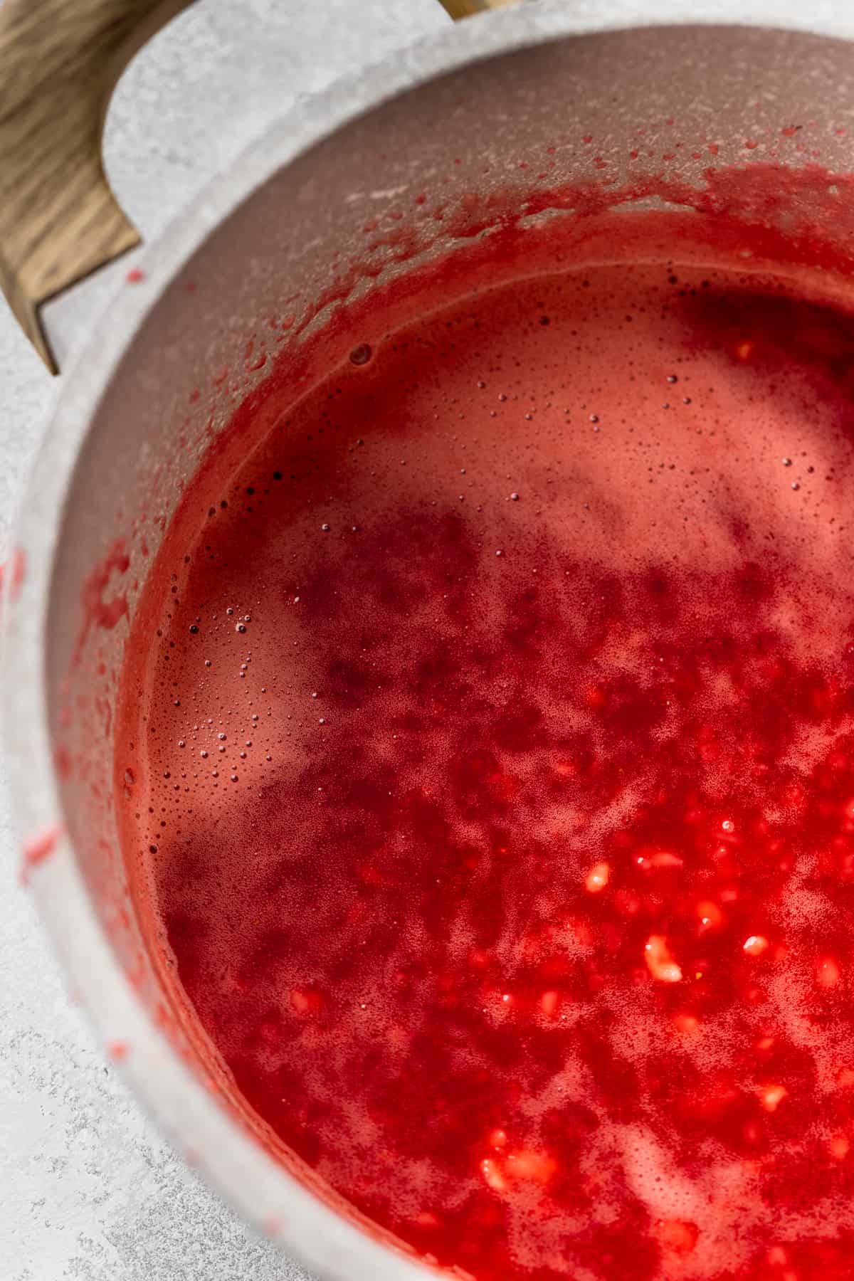 Strawberry glaze in a pot.