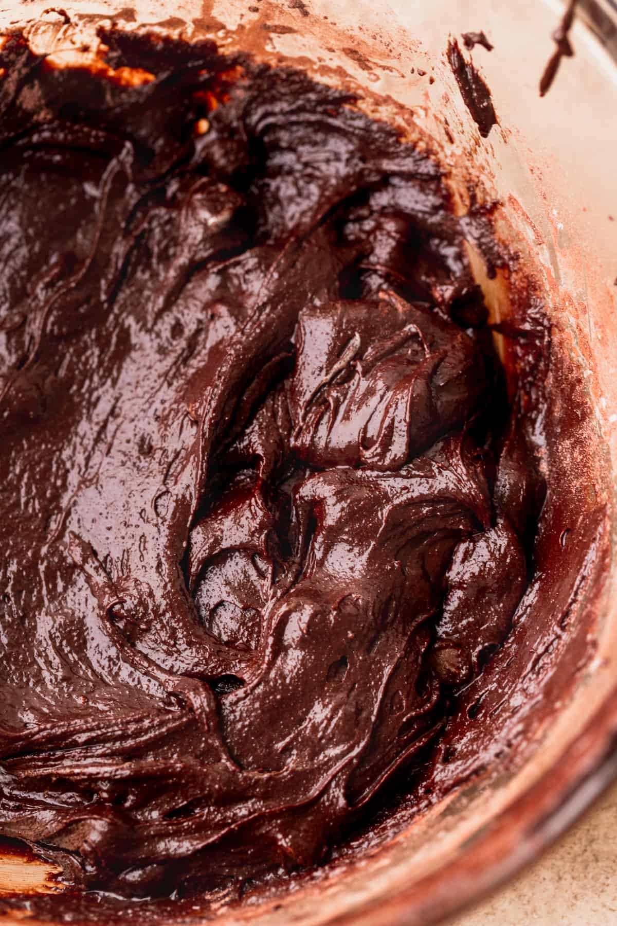 Brownie batter in a glass bowl.