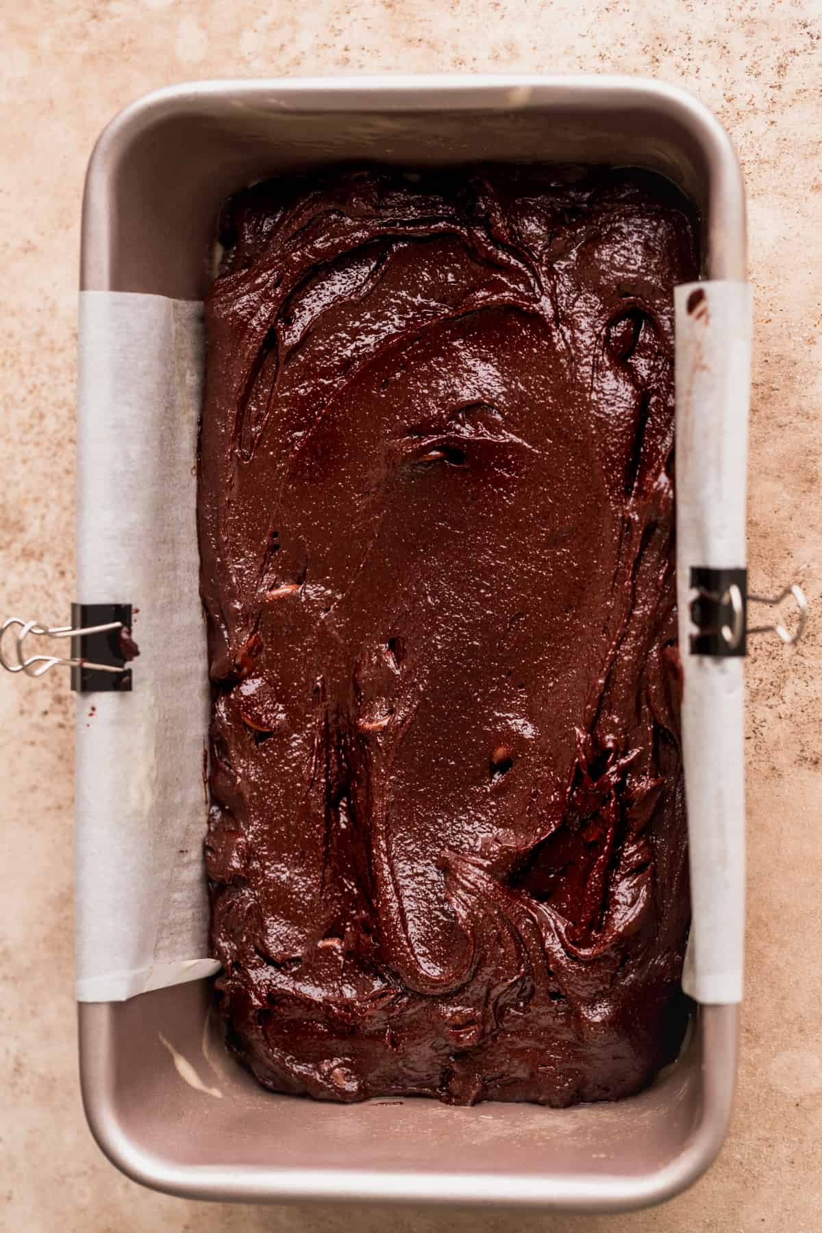 Brownie batter in a loaf pan.