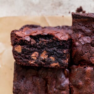 Close up of small batch fudgy brownies with one on it's side.