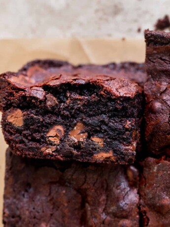Close up of small batch fudgy brownies with one on it's side.