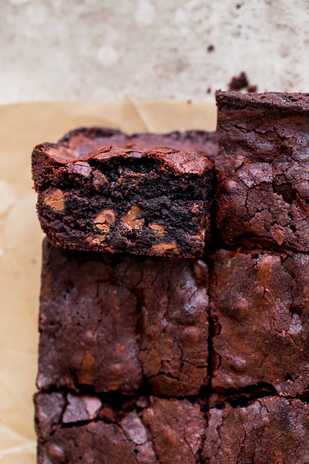 Close up of small batch fudgy brownies with one on it's side.