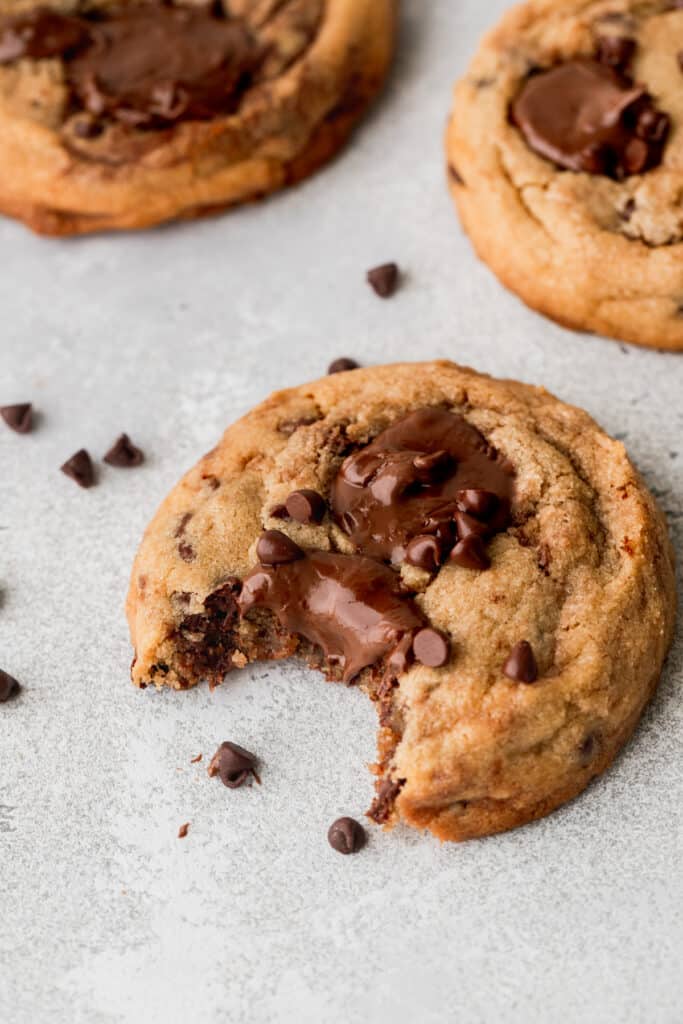 A bite missing from peanut butter Nutella cookies.