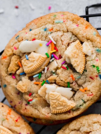 Birthday cake cookies on a circle wire rack.