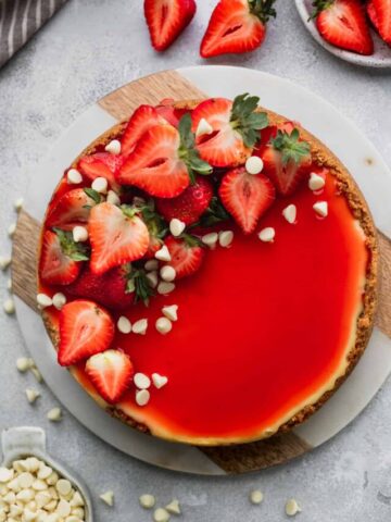 Strawberry white chocolate cheesecake with strawberries on top.