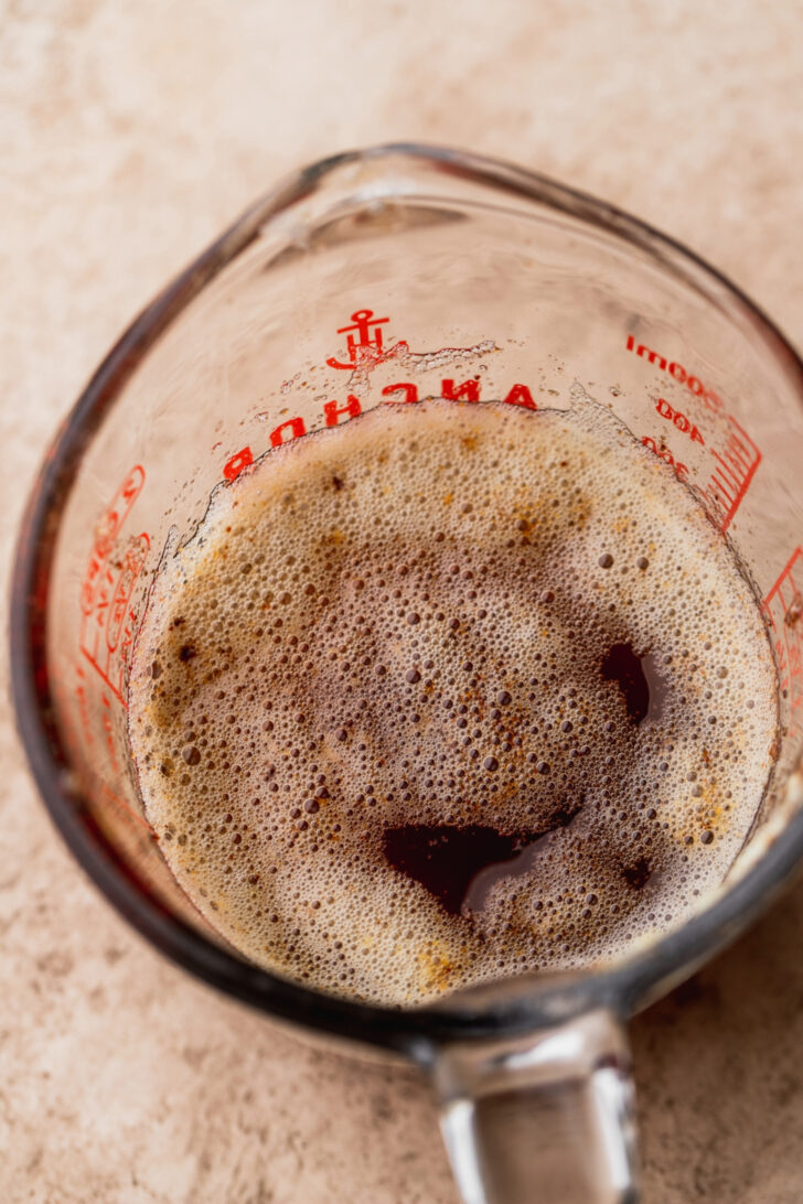 Brown butter in a glass cup.