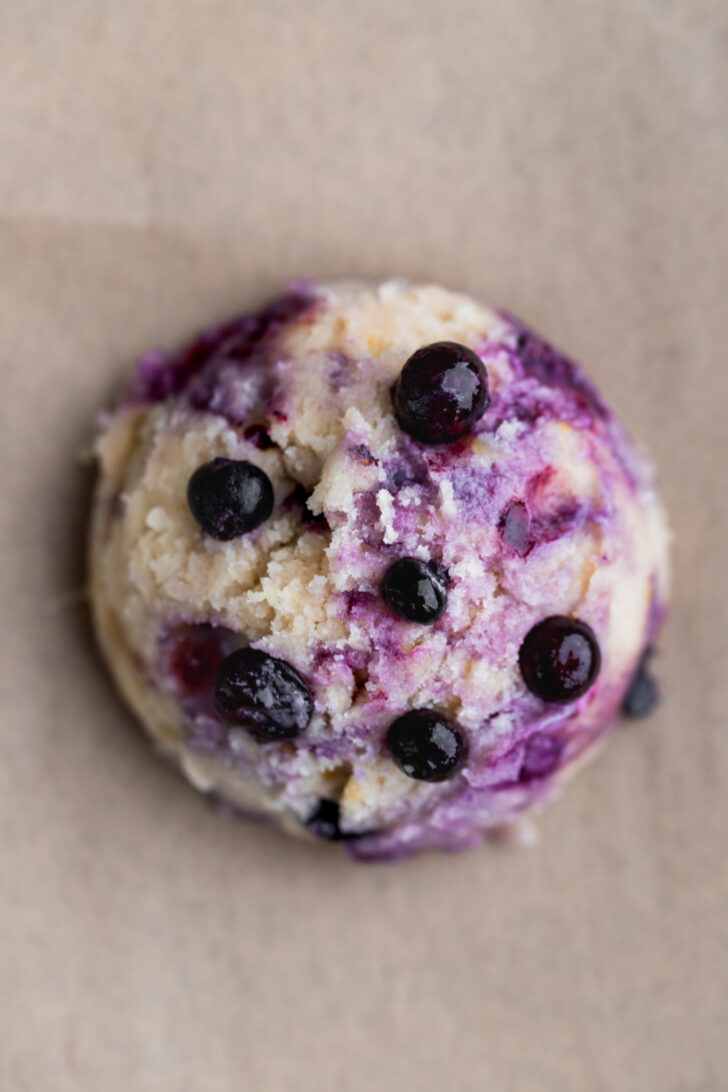 Cookie dough ball with blueberries on top.