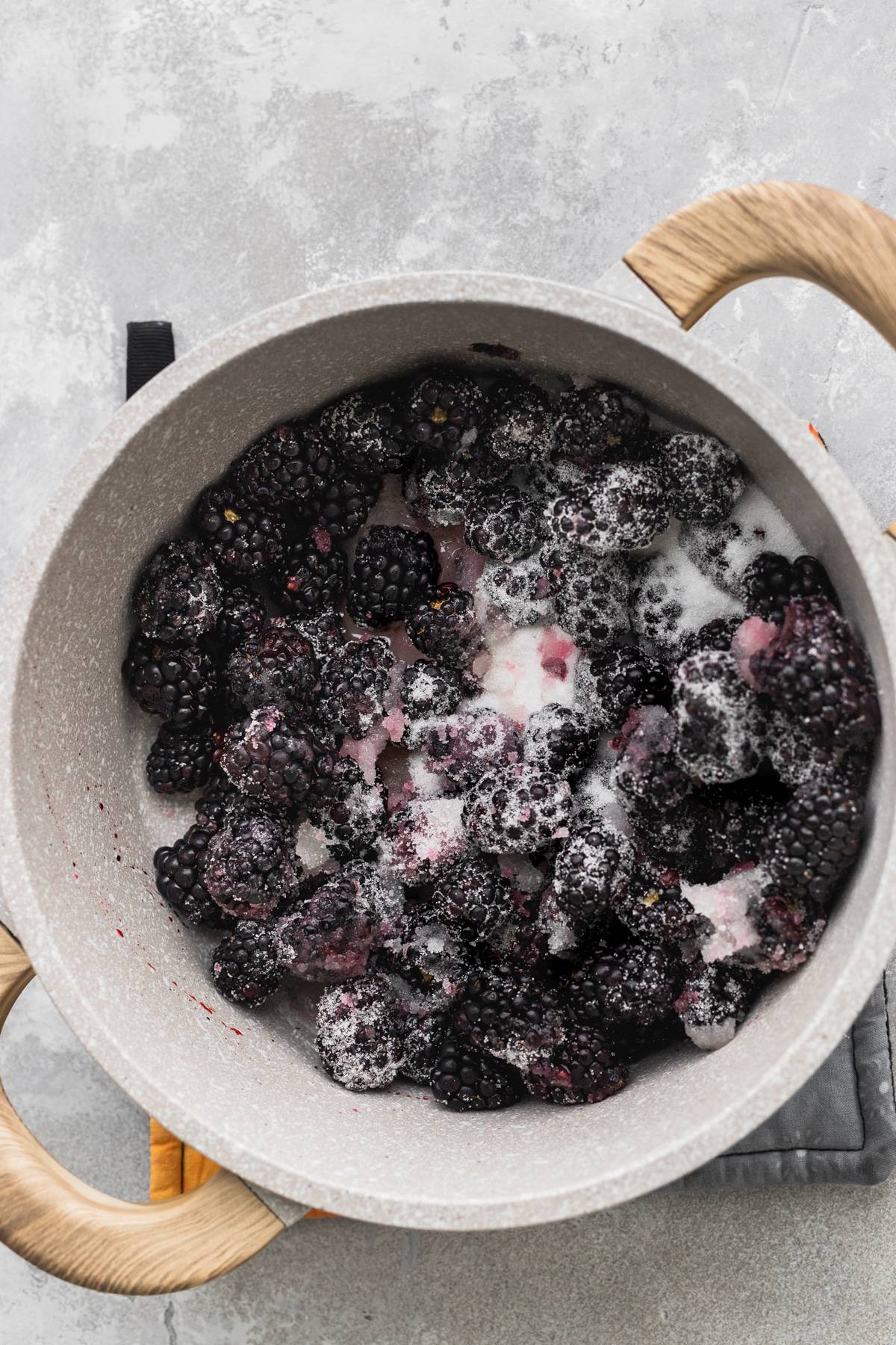 Blackberries and sugar in a pot.