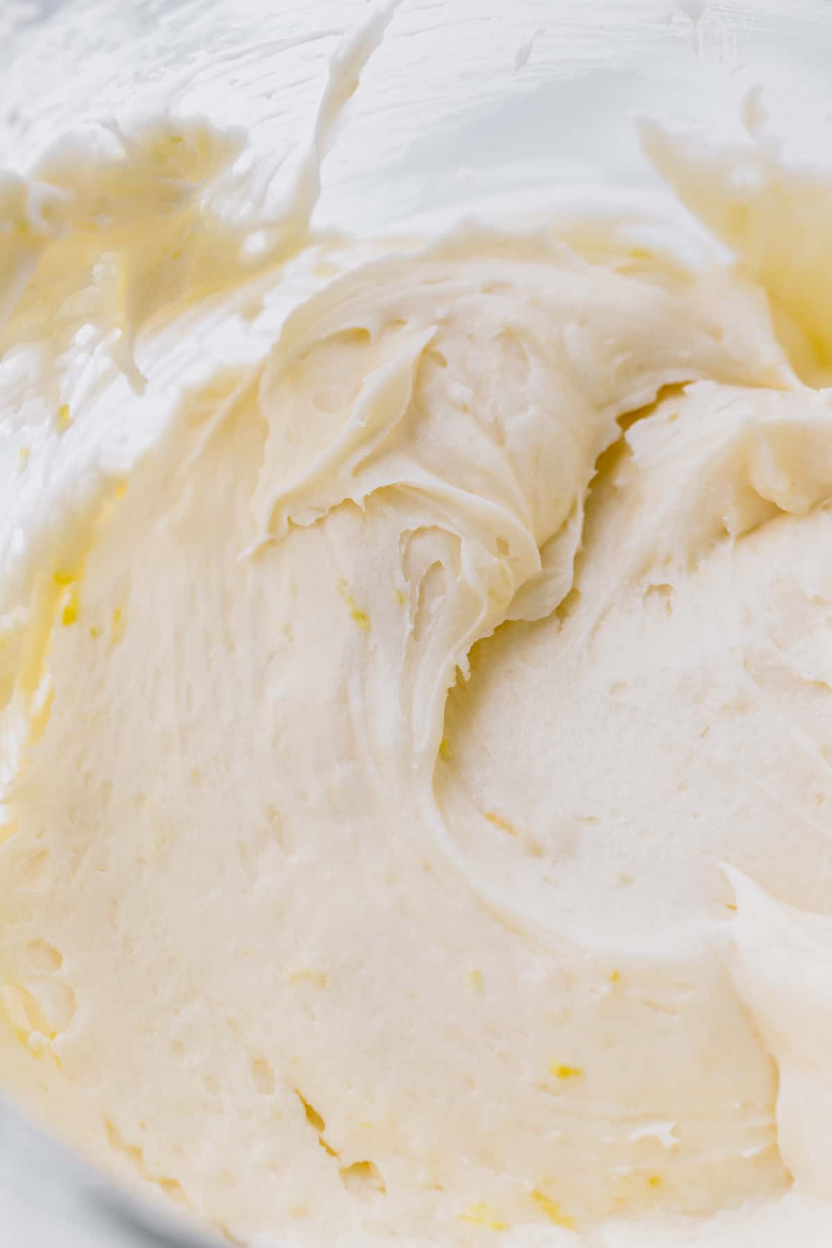 Lemon cream cheese frosting in a glass bowl.