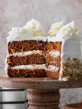Mini carrot cake on a cake stand cut into.