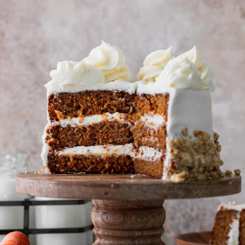Mini carrot cake on a cake stand cut into.