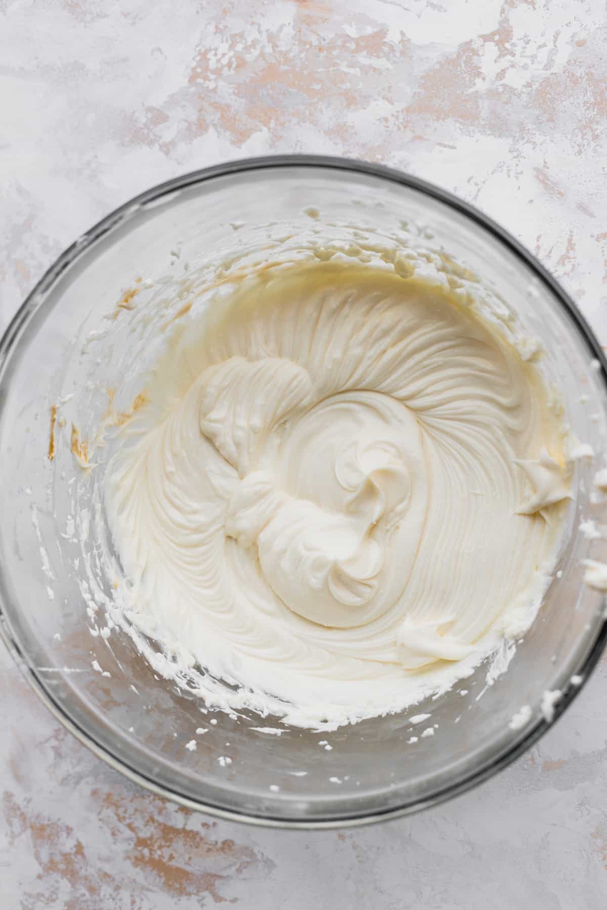 Cream cheese batter in a glass bowl.