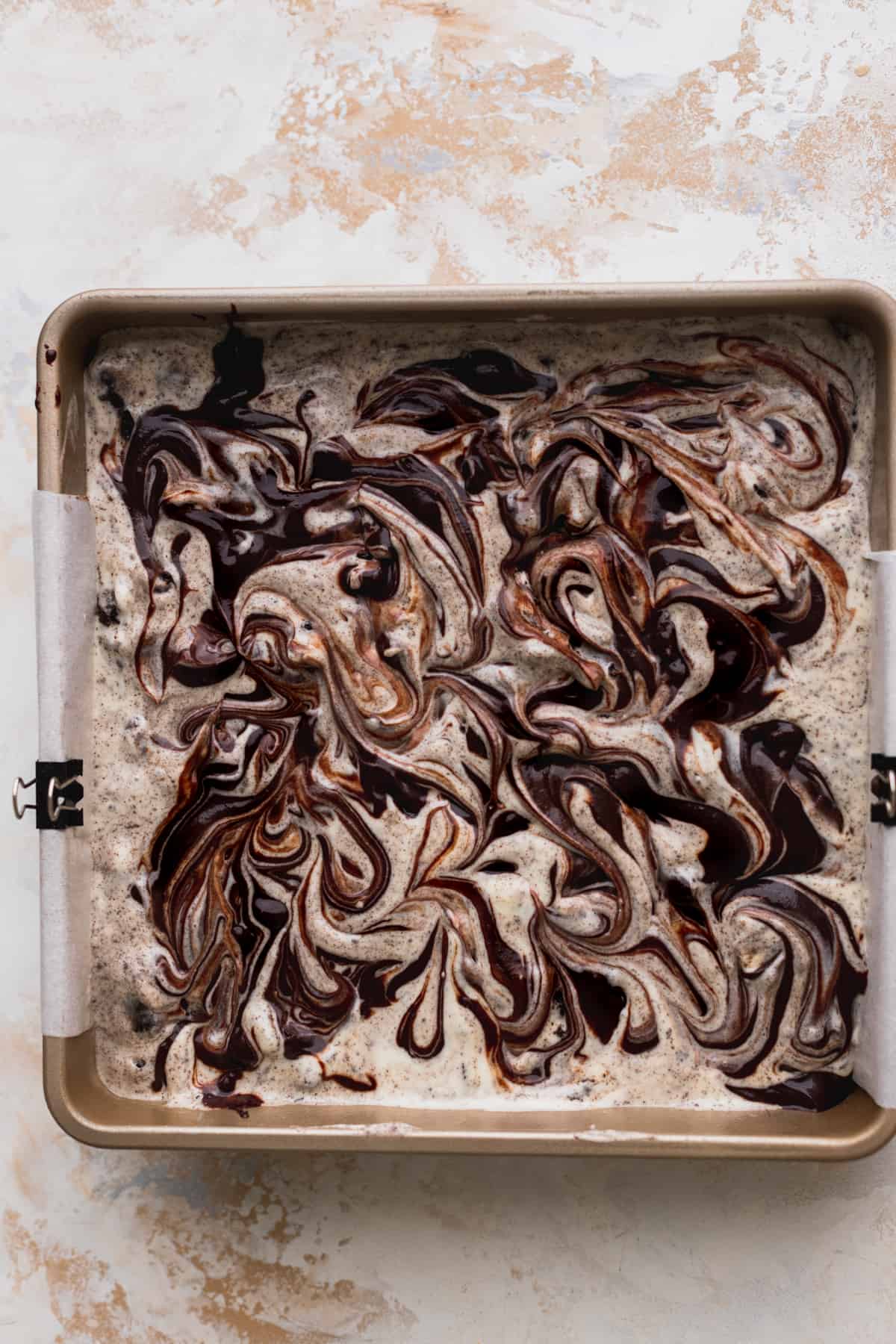 Brownie batter swirled on top of cheesecake batter.