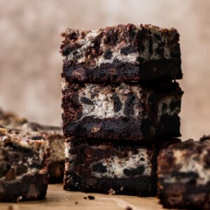 Oreo cheesecake brownies stacked on top of each other.