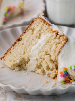 One slice of mini vanilla cake with a bite missing.
