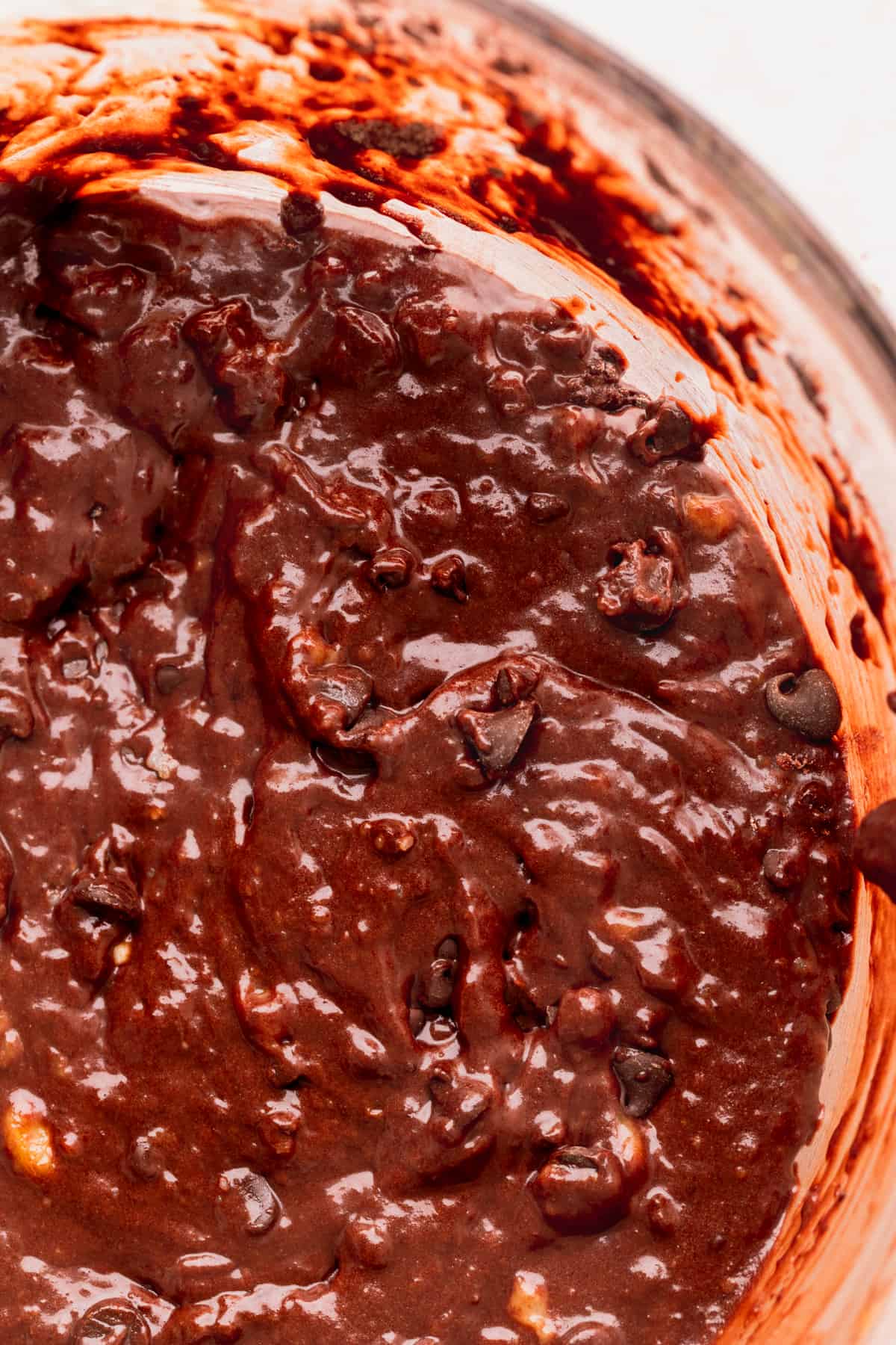 Close up of banana bread batter in a glass bowl.