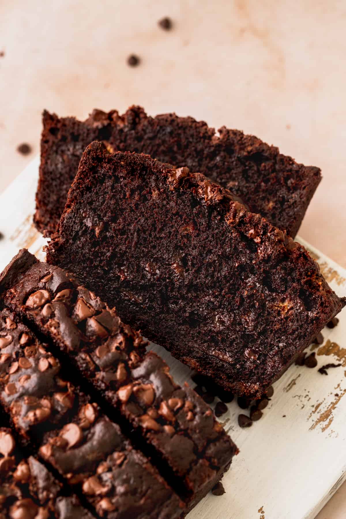 Slices of double chocolate banana bread cut into on a white platter.