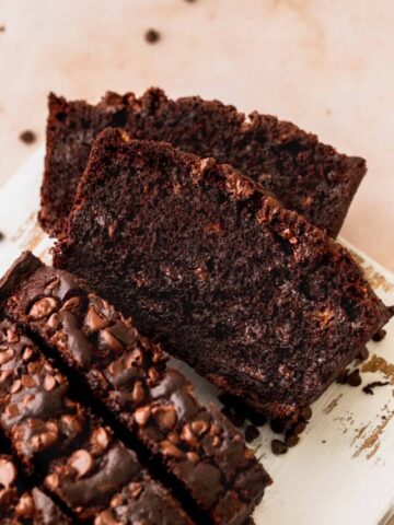Slices of double chocolate banana bread cut into on a white platter.