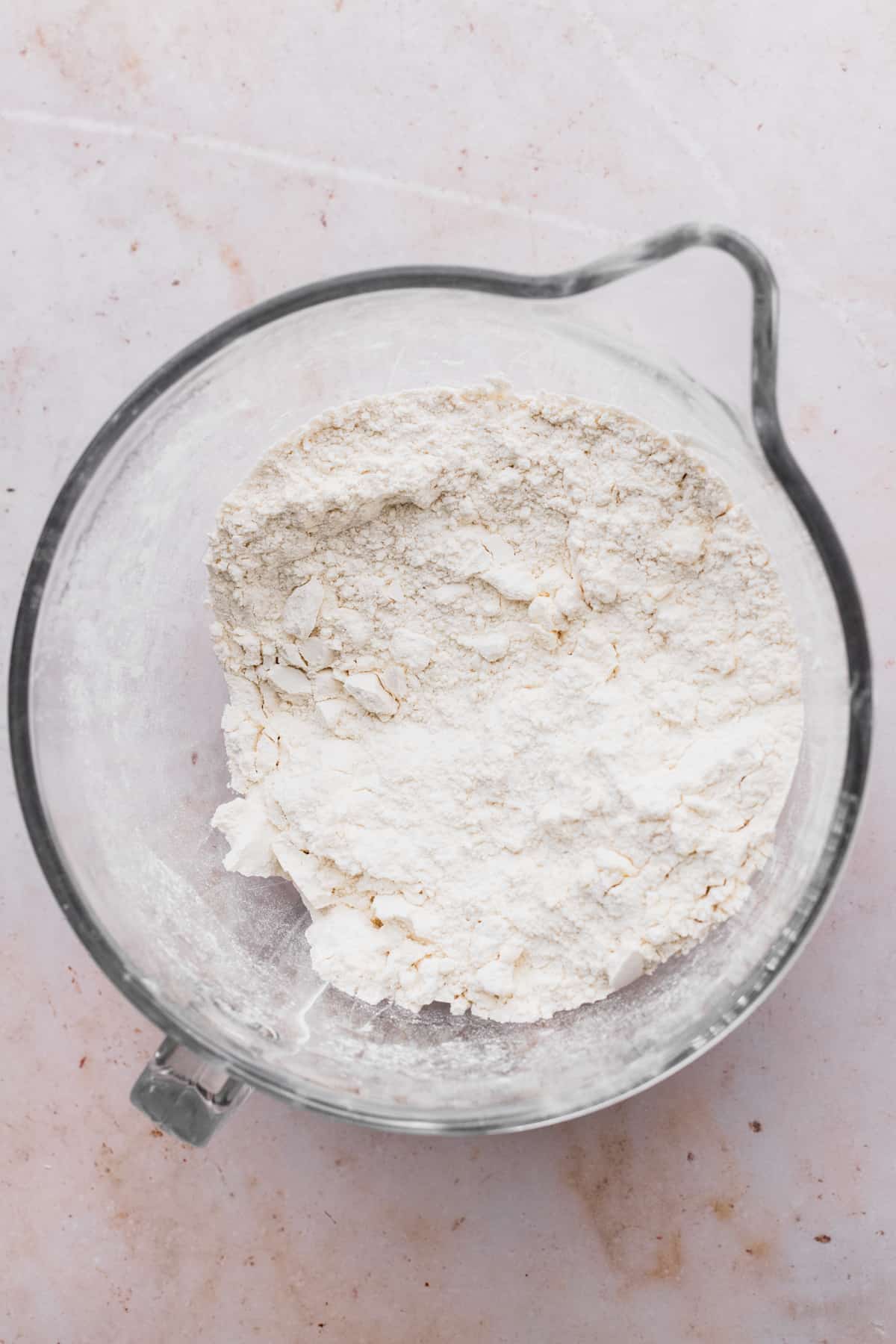 Flour and butter in a glass bowl.