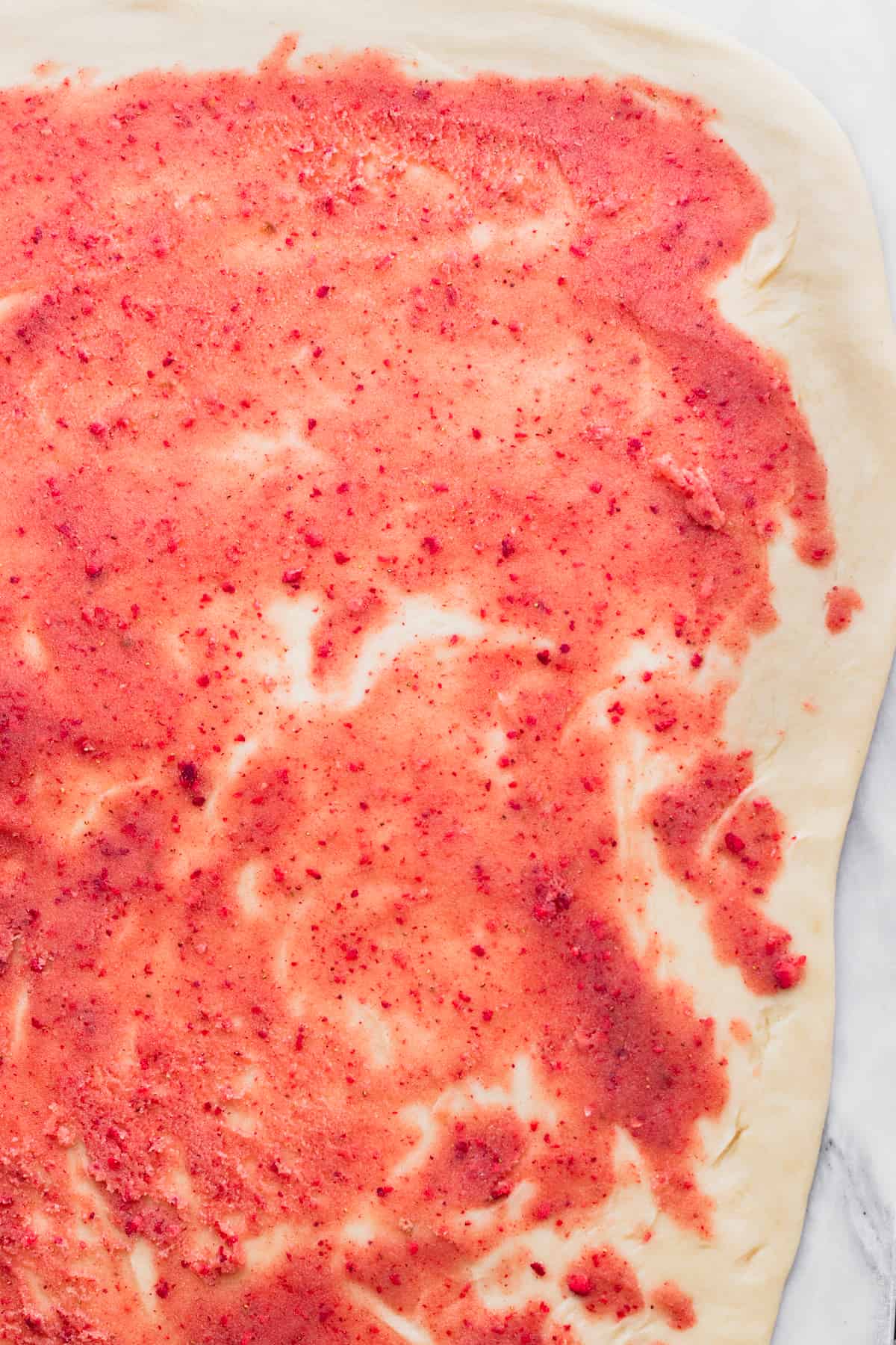 Strawberry filling on top of the dough.
