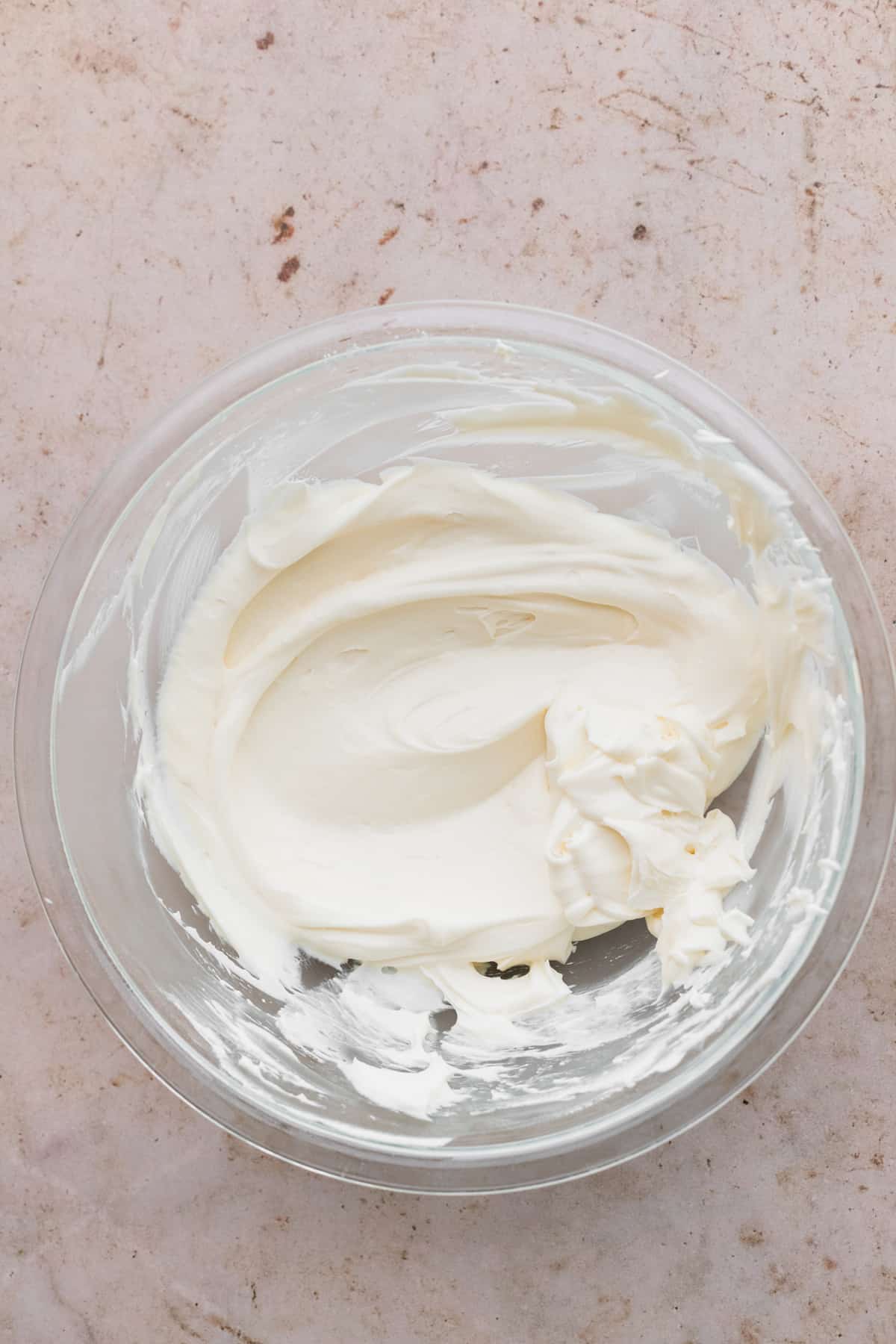 Whipped cream cheese in a glass bowl.