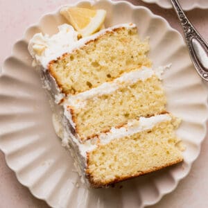 Close up of one slice of lemon white chocolate cake on a plate.