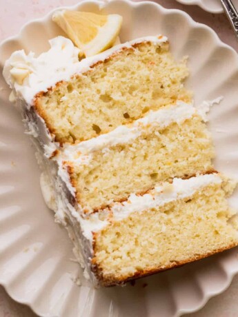Close up of one slice of lemon white chocolate cake on a plate.