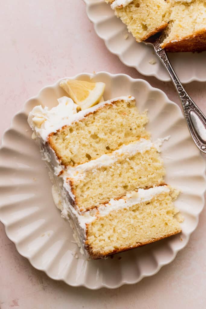 Close up of one slice of lemon white chocolate cake on a plate.
