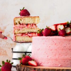 Pulling a slice of cake out of the strawberry vanilla cake.