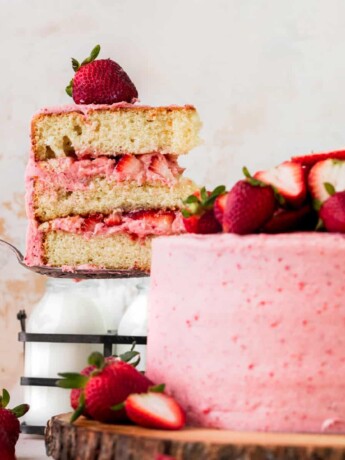 Pulling a slice of cake out of the strawberry vanilla cake.