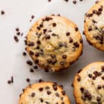 Top view of chocolate chip buttermilk muffins on a marble board.