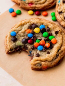 A bite missing from one mini M&M cookie.
