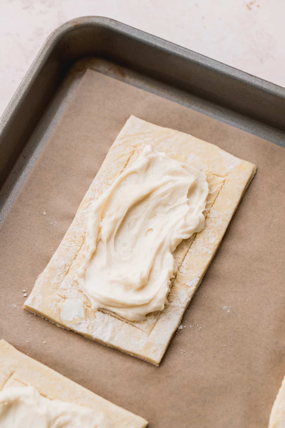 Cream cheese filling on top of one pastry rectangle.