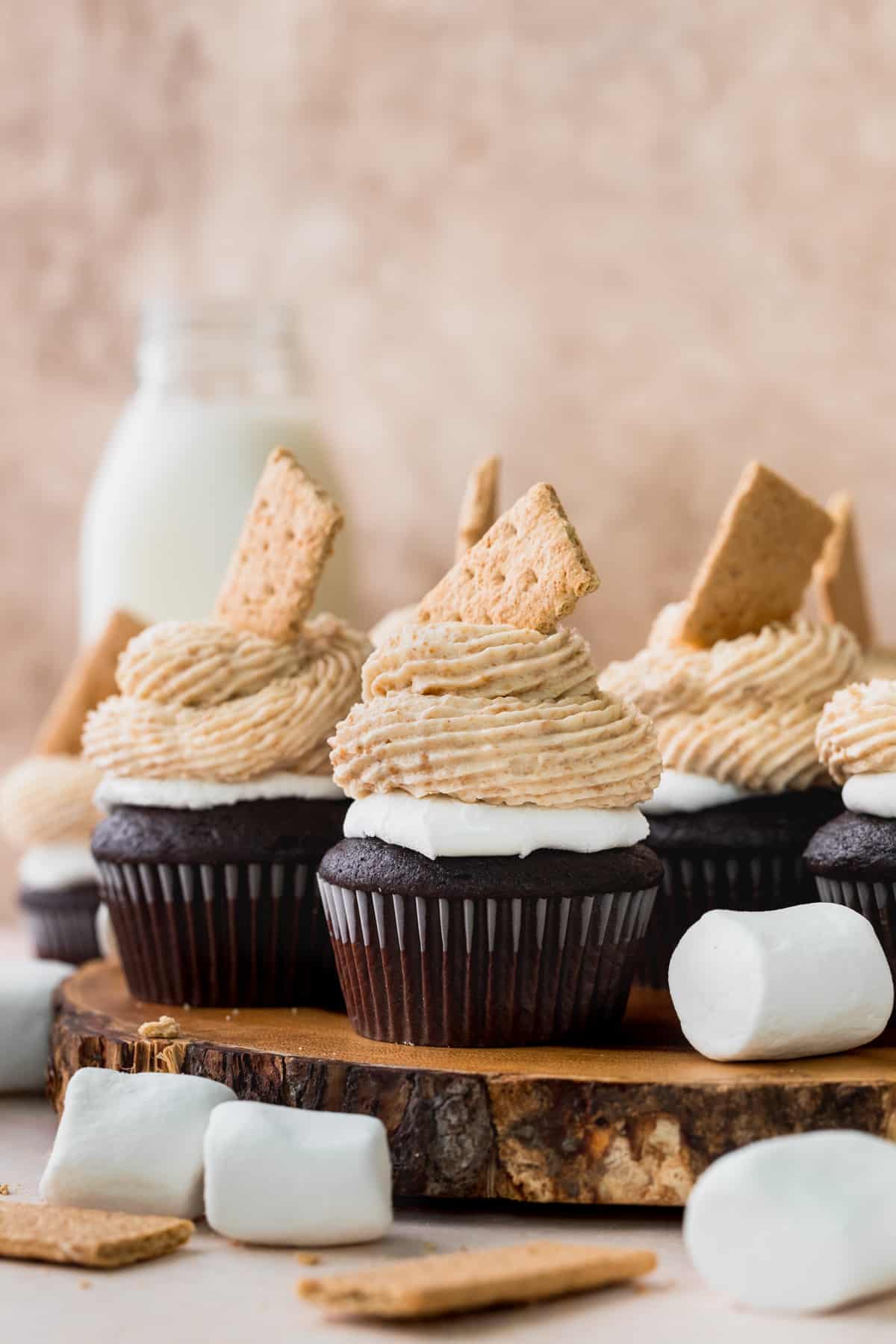 S'mores cupcakes on top of a wooden board.