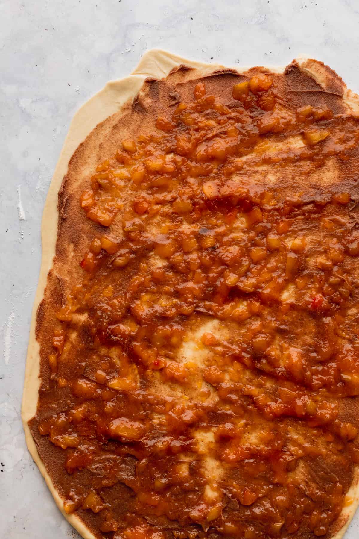 Peach jam on top of the dough.