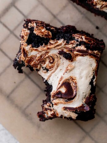 One bite missing from marshmallow brownies.