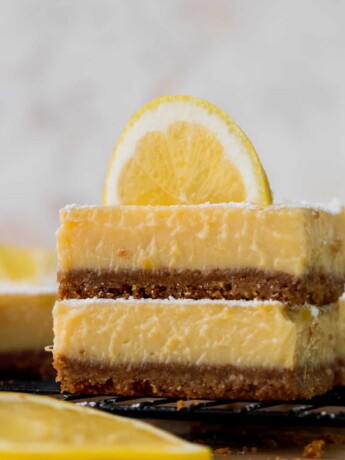 Stack of lemon bars with graham cracker crust.