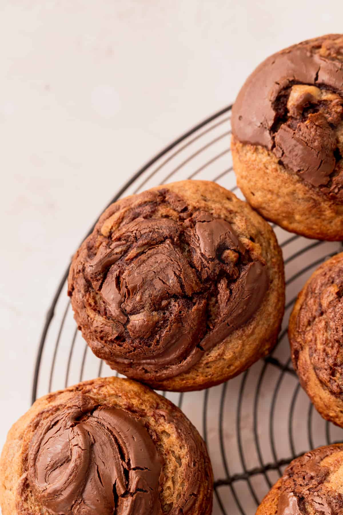 Nutella banana muffins on a wire rack.