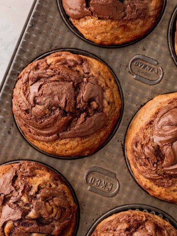 Nutella banana muffins in a muffin pan.