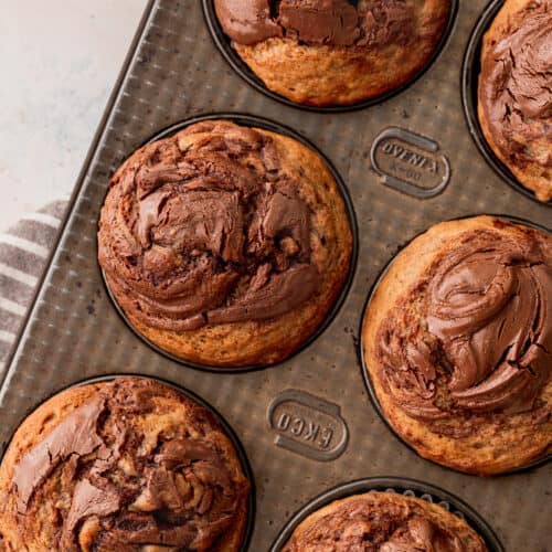 Nutella banana muffins in a muffin pan.