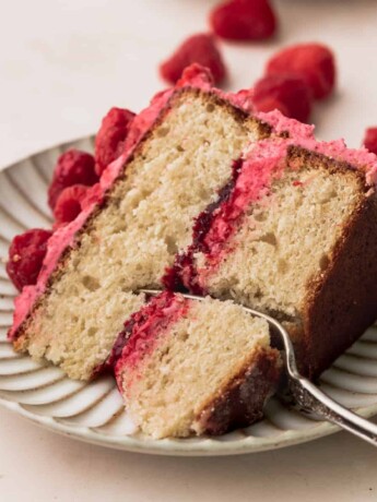 One slice of vanilla raspberry cake on a plate.