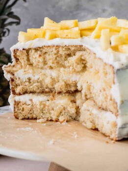 Pineapple sunshine cake cut into on a cake stand.